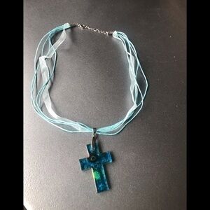 Glass cross with ribbon necklace.